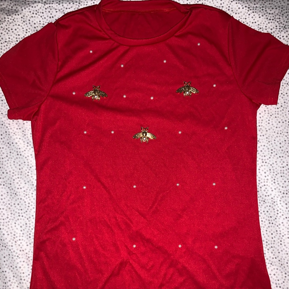 This is a red top with pearls